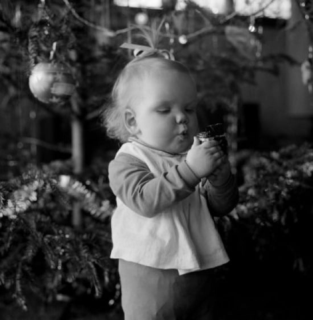 Baby girl holding Christmas bauble Canvas Art - (18 x 24)