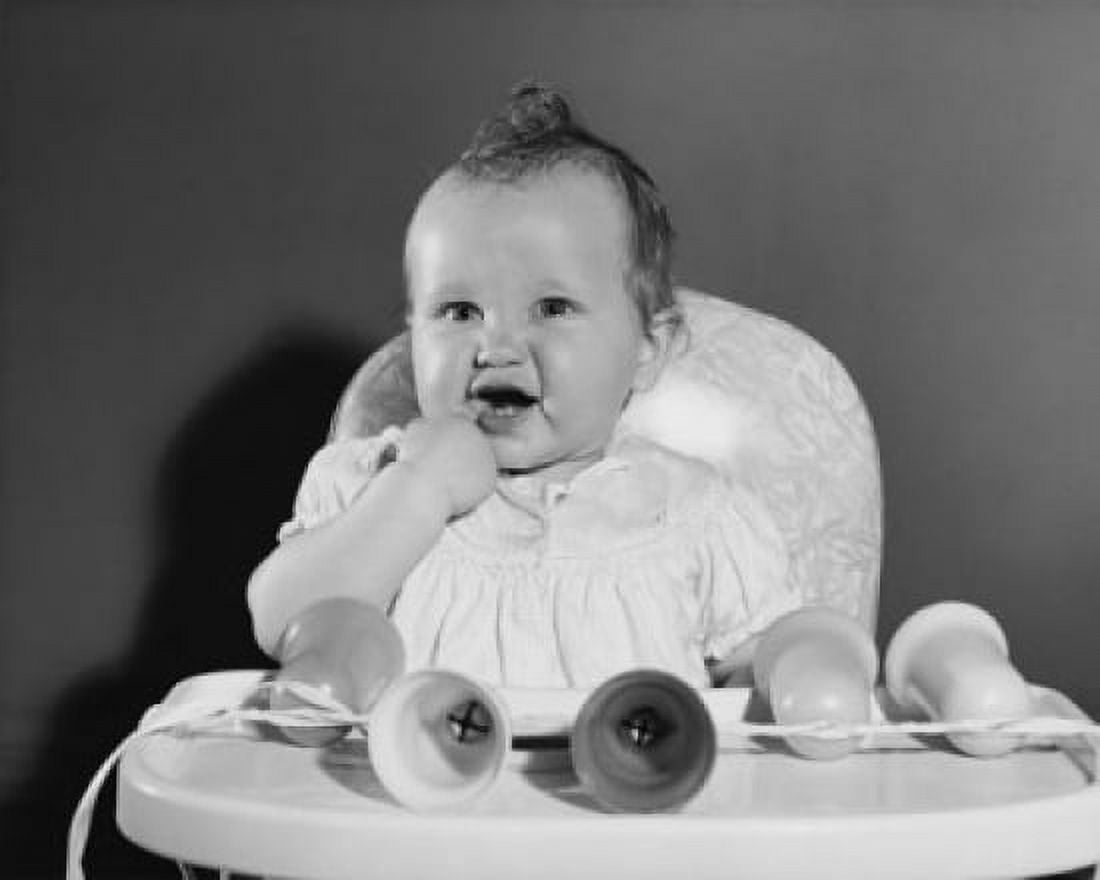 Baby girl sitting in a high chair with her finger in her mouth Canvas Art -  (18 x 24)