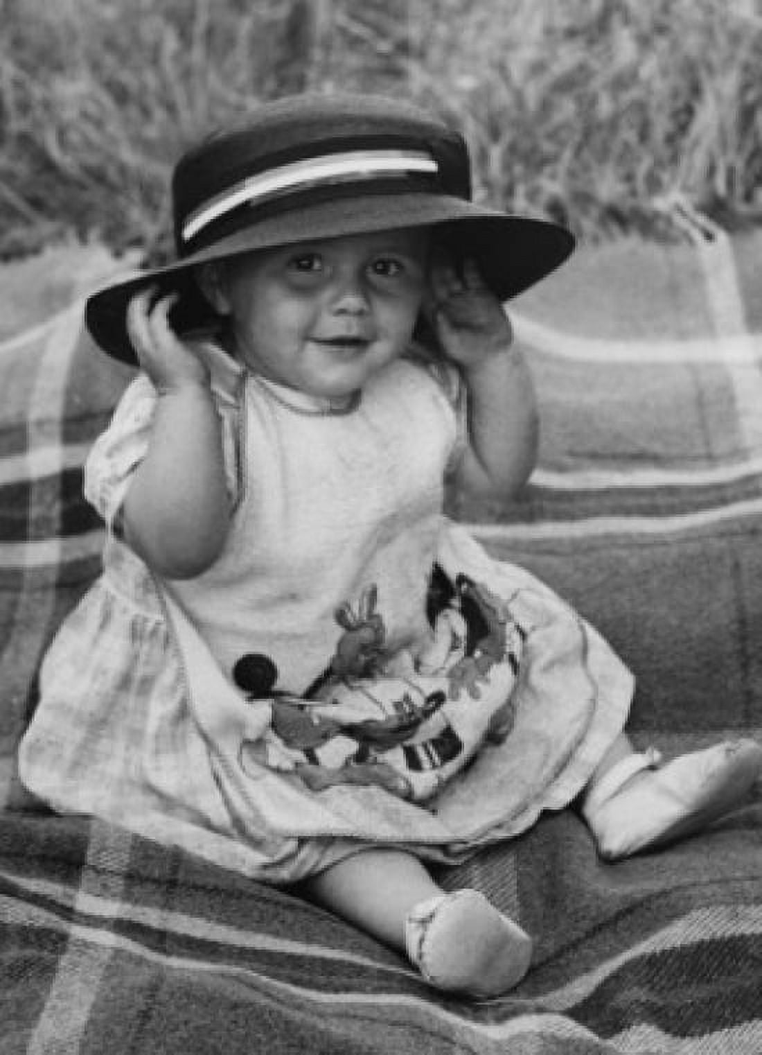 Baby girl sitting on blanket smiling and wearing hat Canvas Art - (24 x 36)