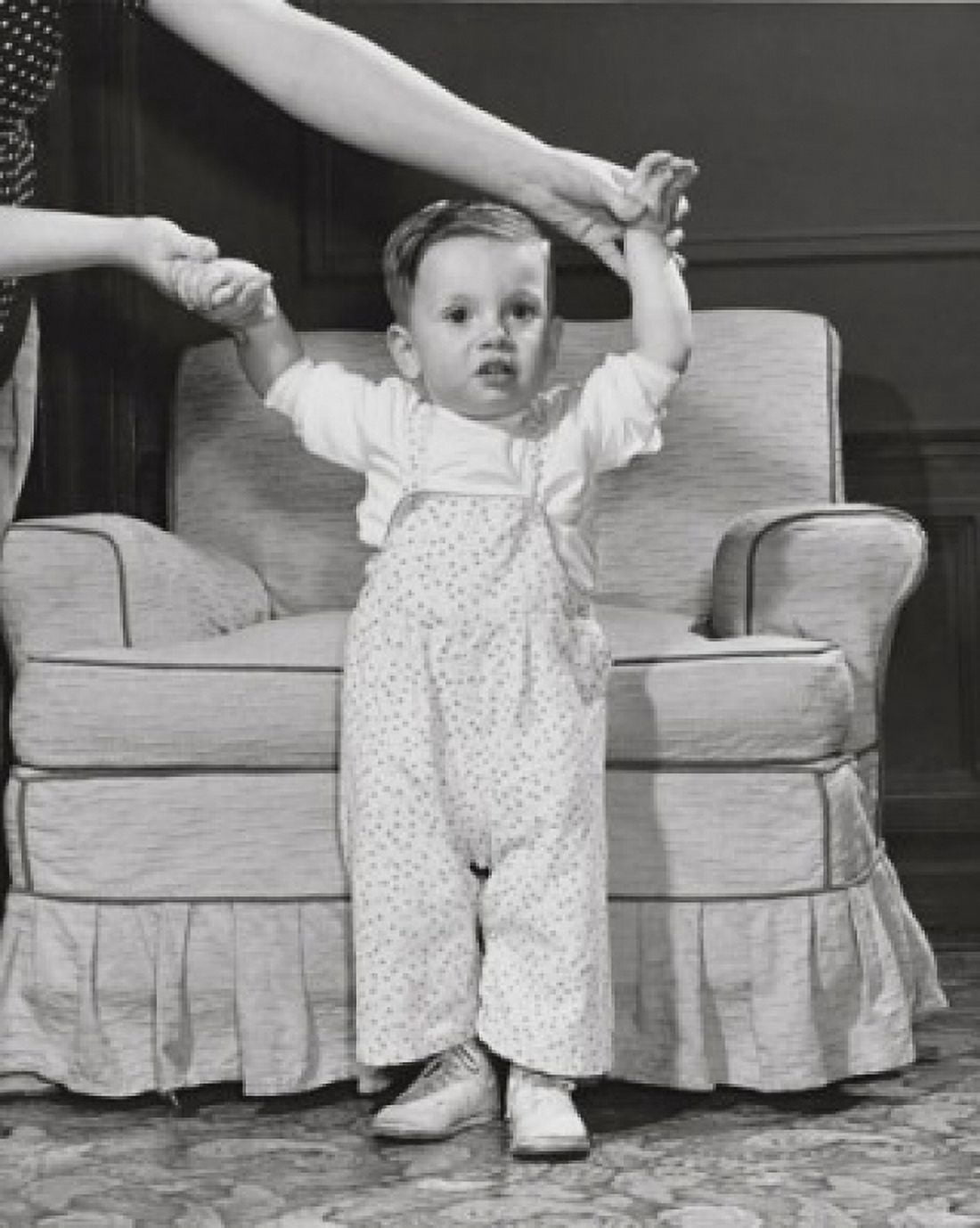Baby girl standing in front of an armchair Canvas Art - (18 x 24)