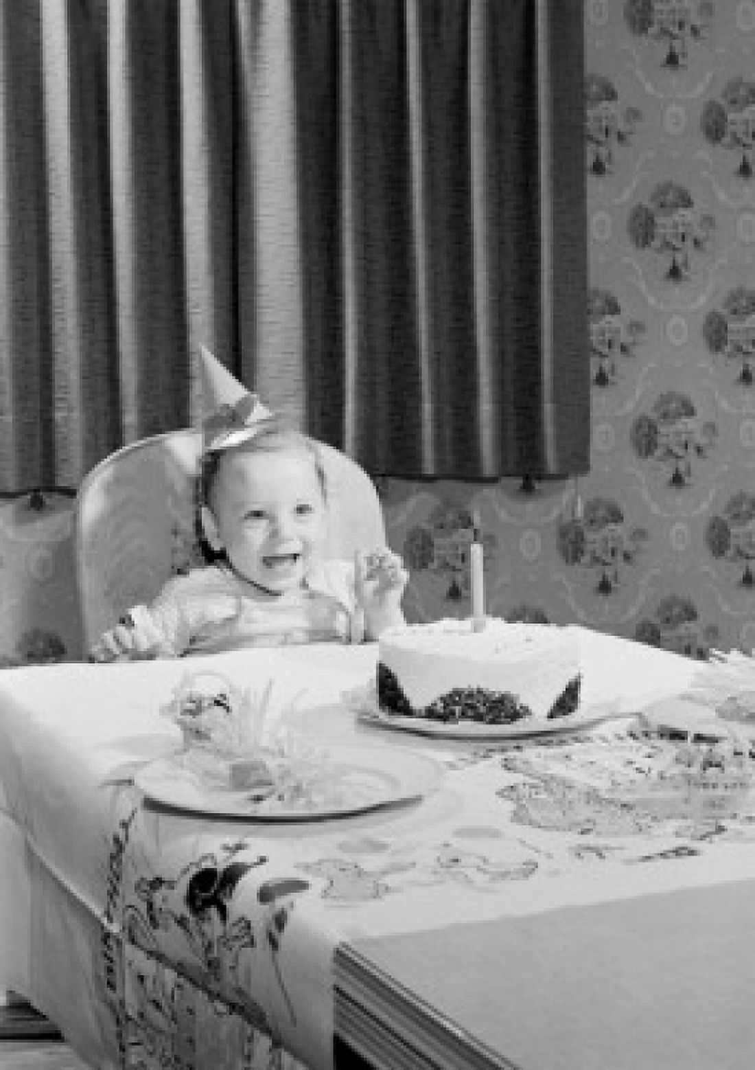 Baby girl wearing birthday hat sitting behind table with birthday cake Canvas Art - (24 x 36)