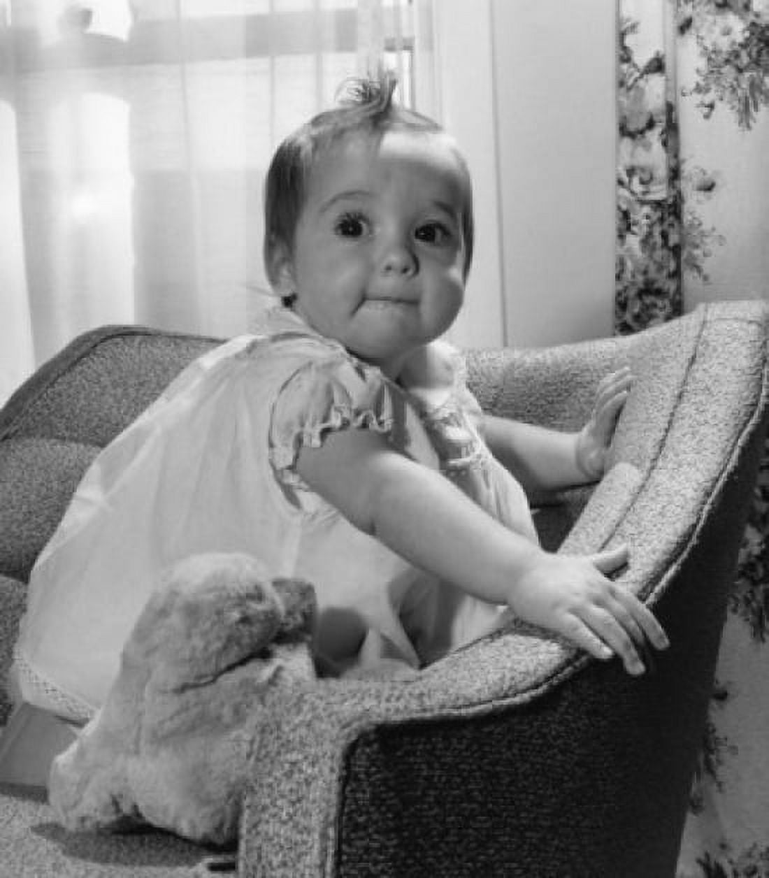 Baby girl with toy on armchair Canvas Art - (18 x 24)