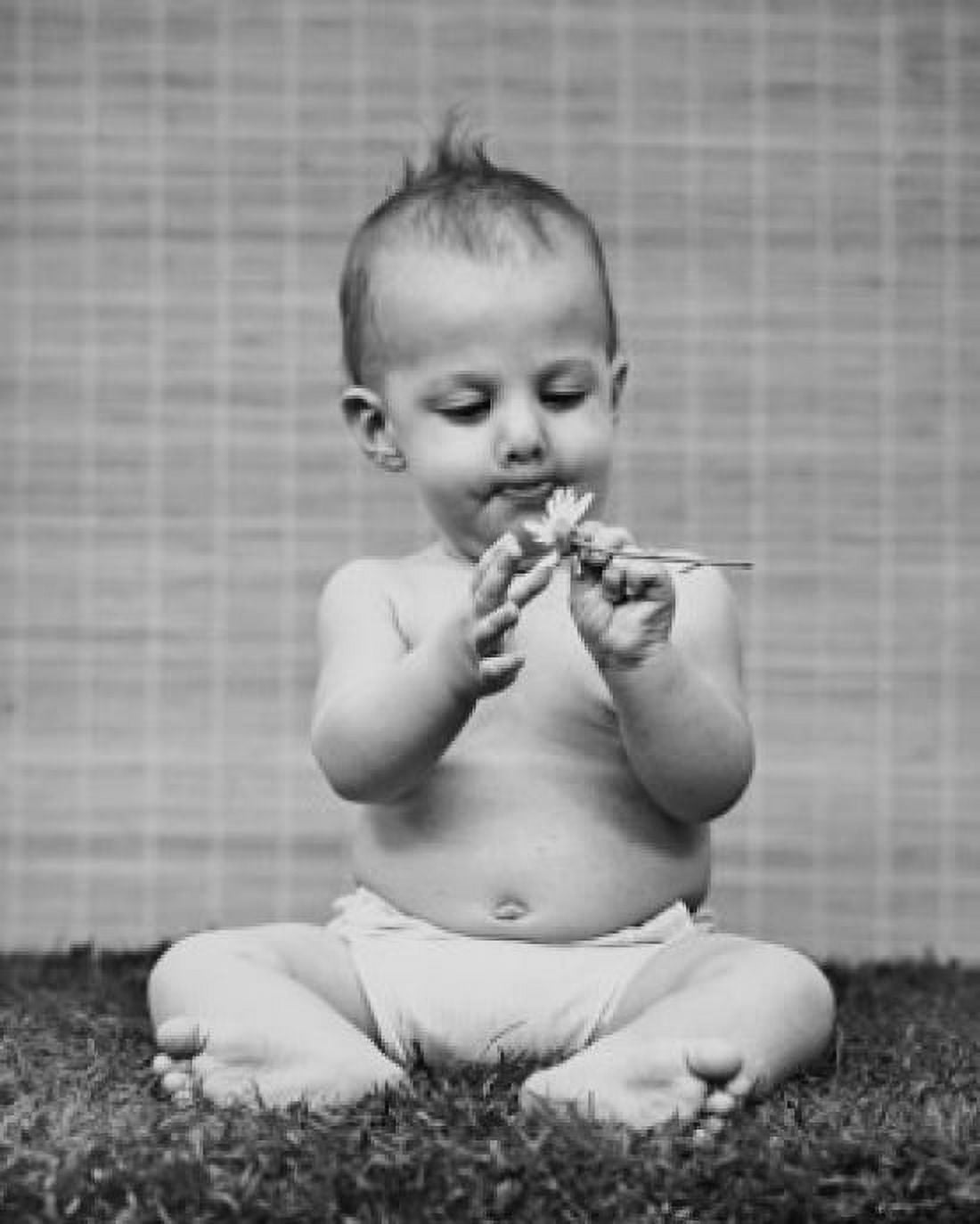 Baby holding a flower Canvas Art - (24 x 36)