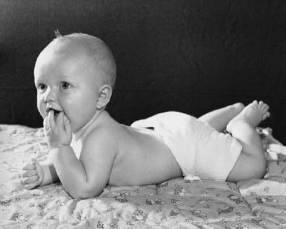 Baby lying on a blanket with its finger in its mouth Canvas Art - (24 x 36)
