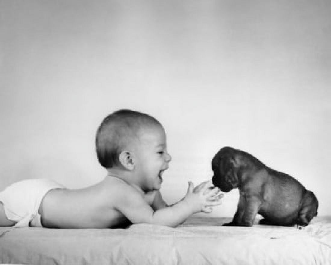 Baby playing with puppy on bed Canvas Art - (18 x 24)