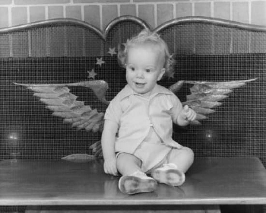 Baby sitting by a fireplace Canvas Art - (18 x 24)