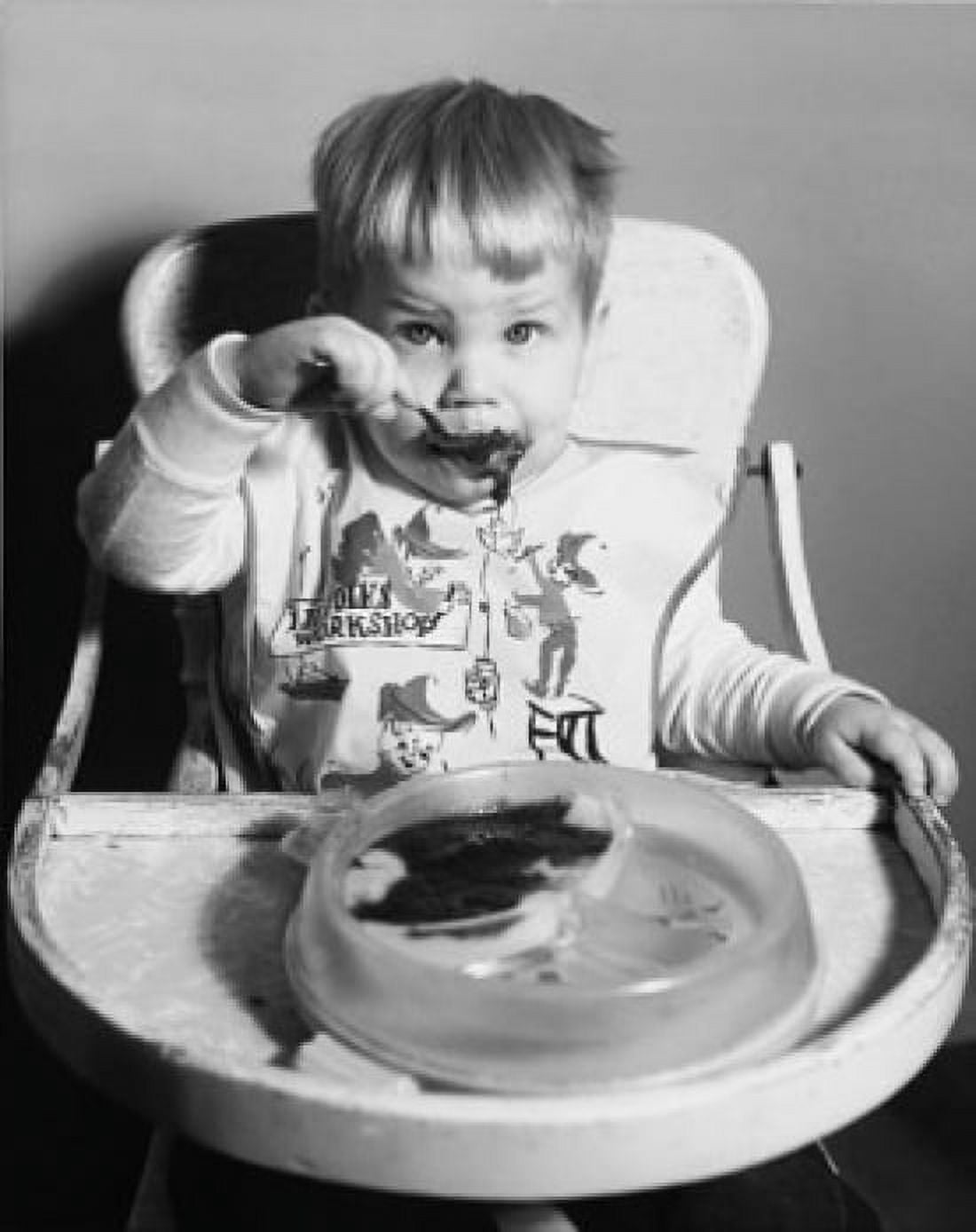 Baby sitting in a high chair and eating baby food Canvas Art -  (24 x 36)