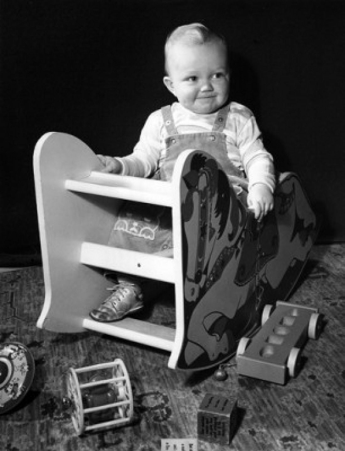 Baby sitting in toy chair Canvas Art - (24 x 36)