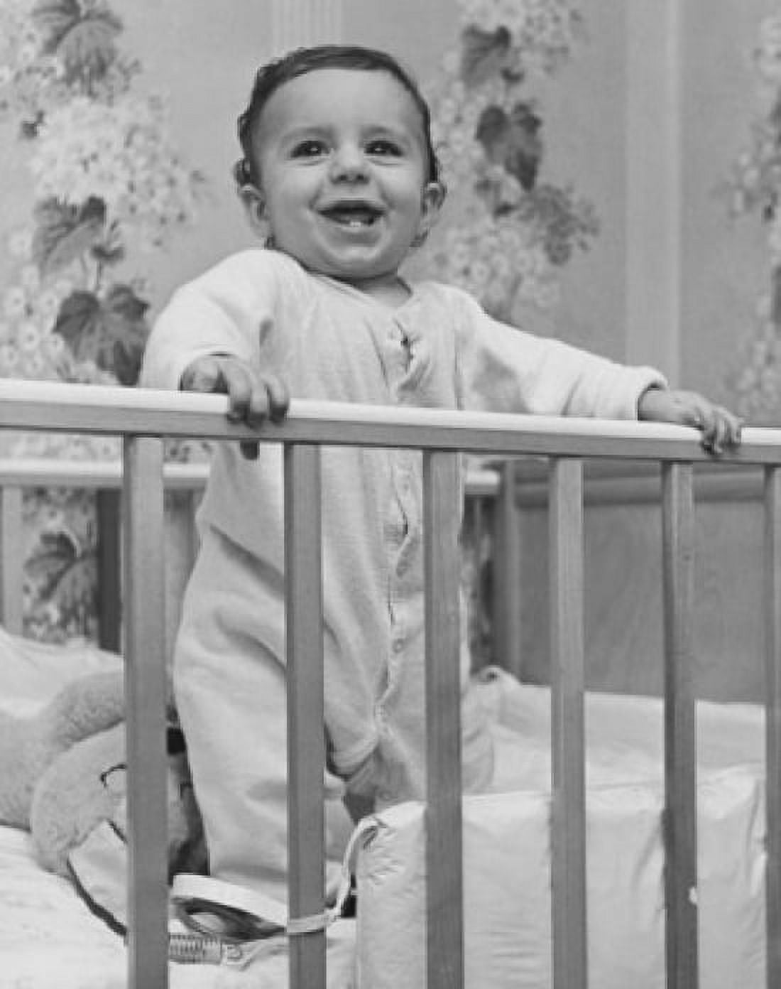 Baby smiling and standing in a crib Canvas Art - (24 x 36)