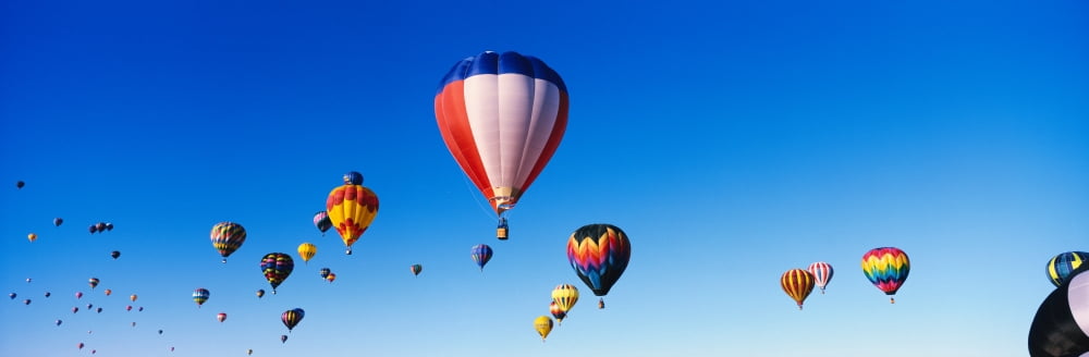Balloons floating in blue sky Canvas Art - Panoramic Images (36 x 12)