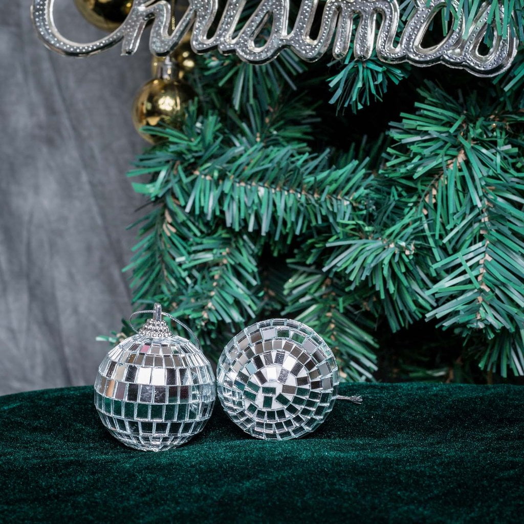Silver and gold disco balls hang from the ceiling on New Years eve Holiday  Stock Photos