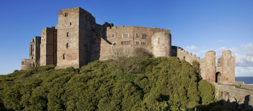 Bamburgh Castle Ruins Against A Blue Sky Bamburgh Northumberland England Canvas Art - John Short Design Pics (32 x 14)