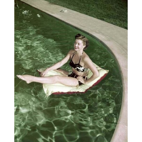 Barbara Stanwyck in black bikini on flotation device in her pool 8x10 inch photo