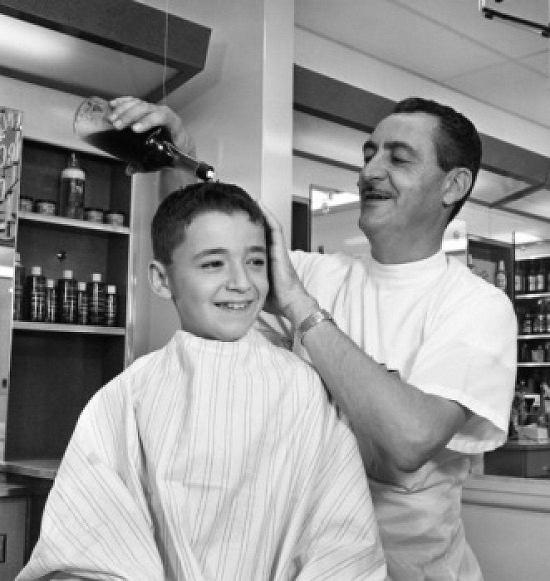 Barber applying cosmetics on boys head Canvas Art - (18 x 24)
