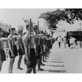thumbnail image 1 of Barefoot Villagers Perform Training Drills Using 'Bamboo Rifles' At A French Legionnaire Outpost. Batri History (, 1 of 1