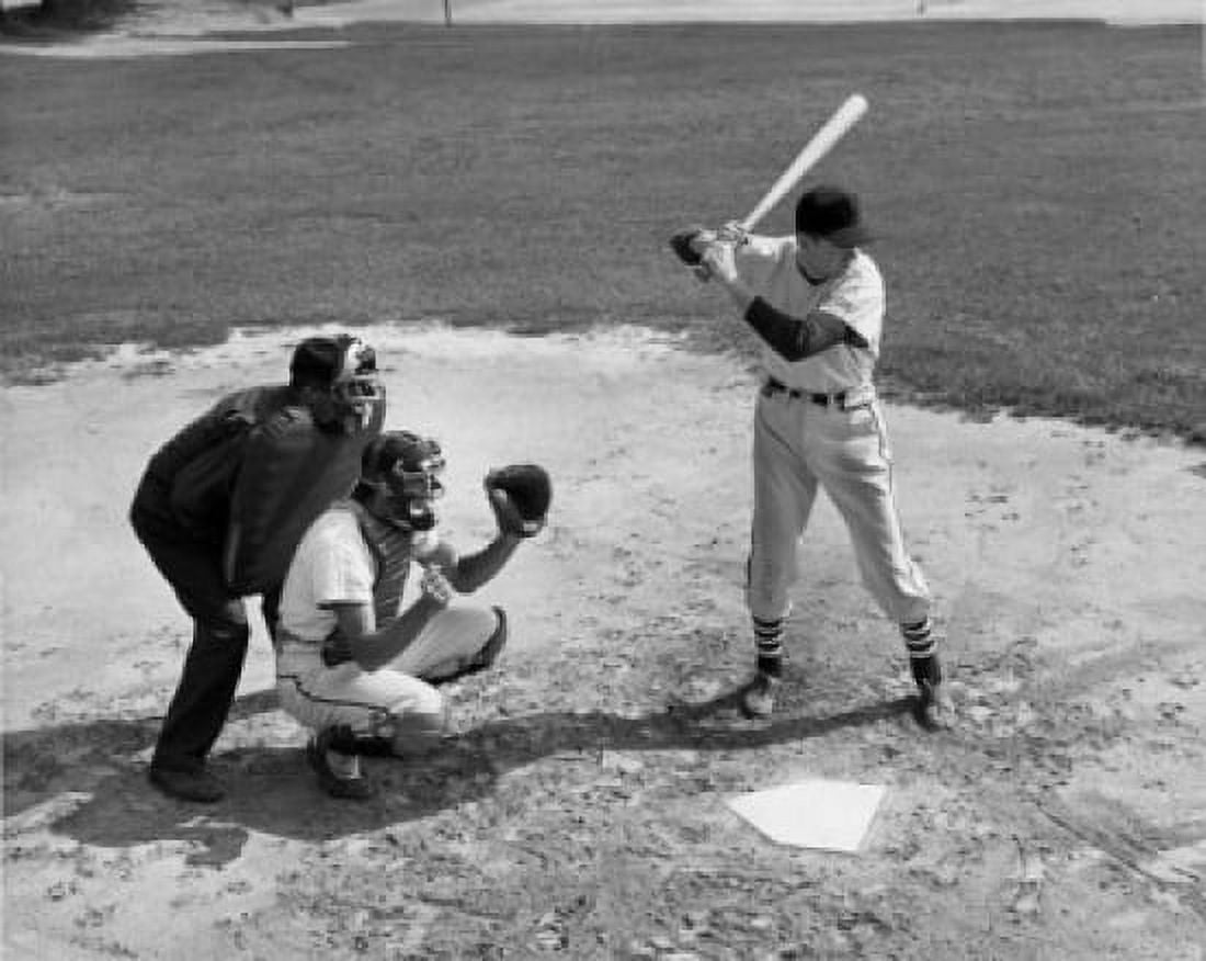 Baseball player swinging baseball bat with baseball catcher and baseball umpire squatting beside him Canvas Art - (18 x 24)