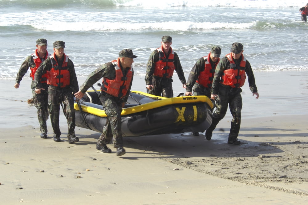 Basic Underwater DemolitionSEAL students bring their boat out from the water Canvas Art - Stocktrek Images (34 x 23)