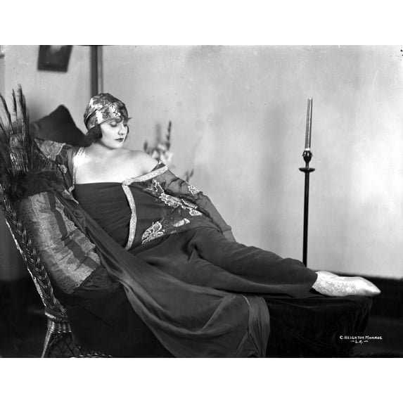 Betty Blythe Lying on the Black Reclining Bed in Black Strapless Sheer Sleeve Velvet Dress and Cotton Bandana Headband Photo Print (8 x 10)
