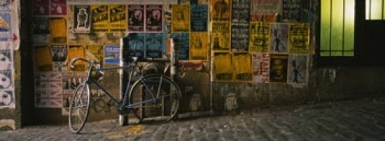 Bicycle leaning against a wall with posters in an alley Post Alley Seattle Washington State USA Canvas Art - Panoramic Images (36 x 13)