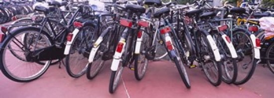 Bicycles parked in a parking lot Amsterdam Netherlands Canvas Art - Panoramic Images (36 x 13)