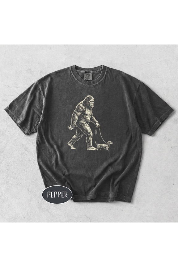Bigfoot Walking Dachshund Unisex T-Shirt Funny Sasquatch Dog Walker Shirt Vintage Cute Wiener Tee Retro Cryptid Dog Lover Gift