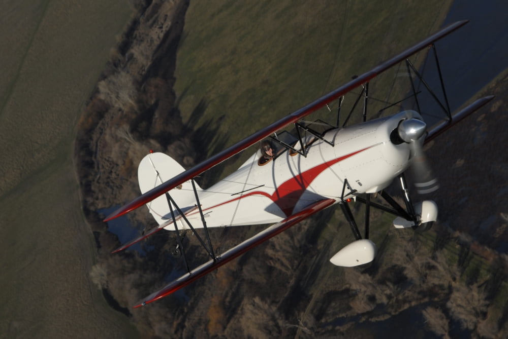 Biplane flying over North Sacramento Valley California Canvas Art - Phil WallickStocktrek Images (17 x 12)
