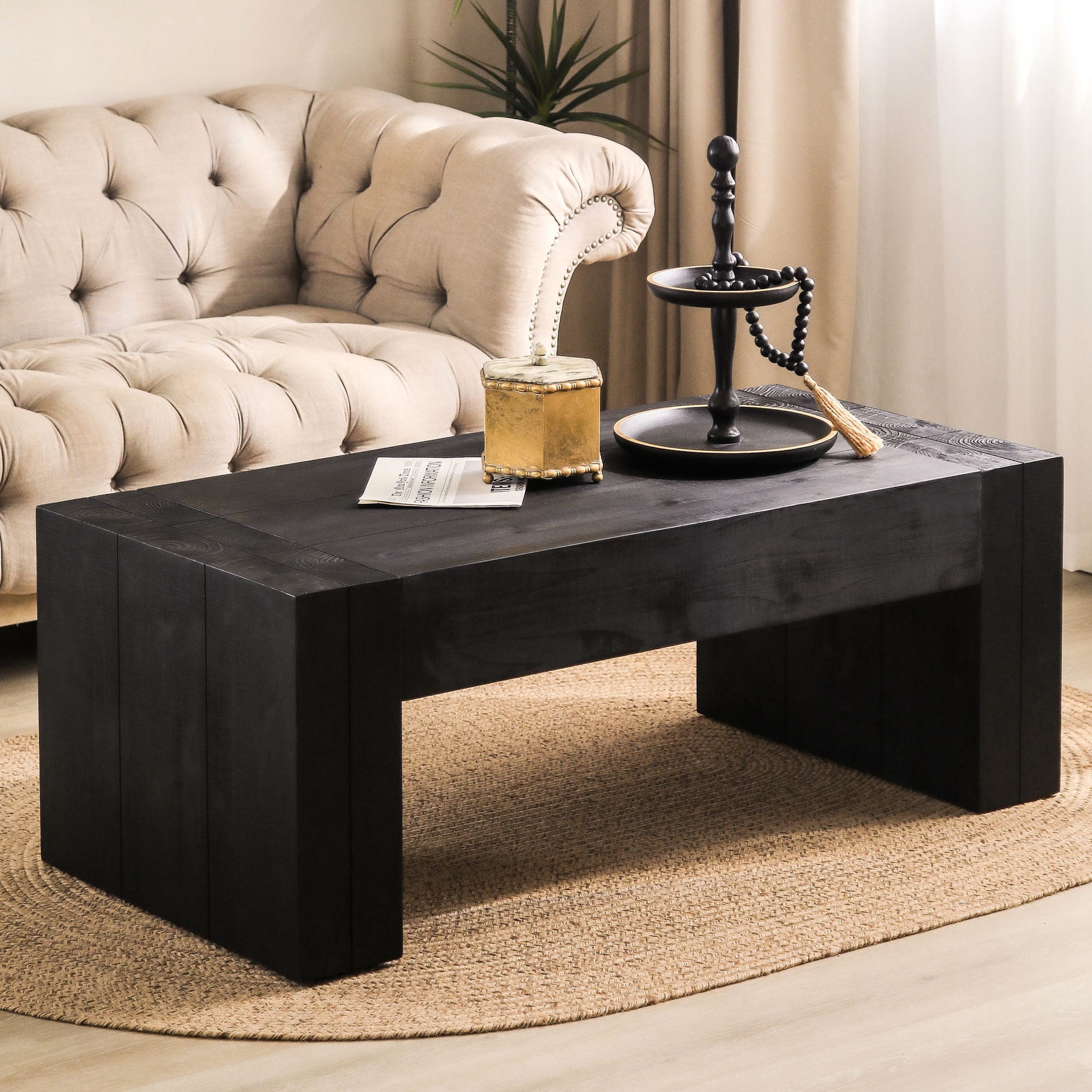 Black solid wood coffee table with visible tree rings, adding elegance ...