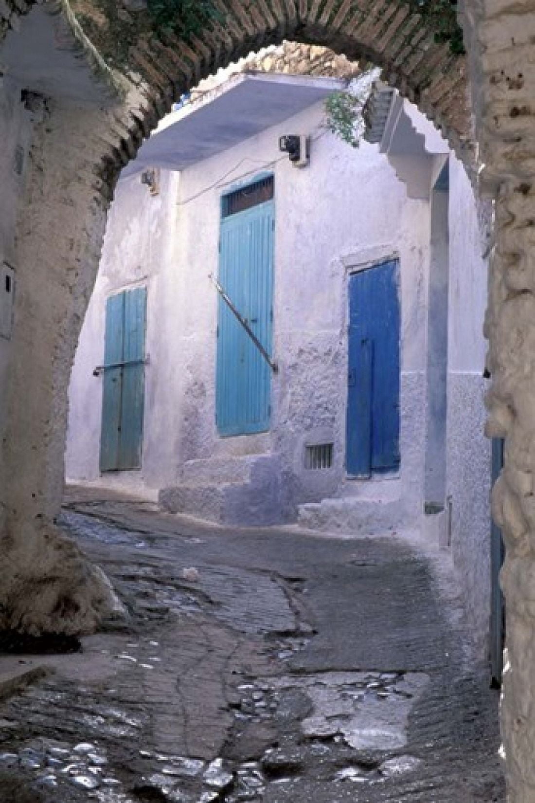 Blue Doors and Whitewashed Wall Morocco Canvas Art - John & Lisa Merrill DanitaDelimont (24 x 36)