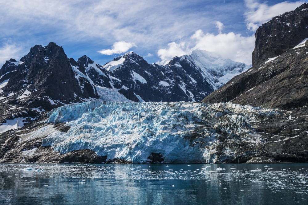 Blue glacier between snow-capped mountains and fjord Antarctica Canvas Art - Nick Dale Design Pics (38 x 24)