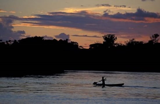 Boaters on Amazon River at Sunset Amazon River Basin Peru Canvas Art - Nik Wheeler DanitaDelimont (27 x 18)