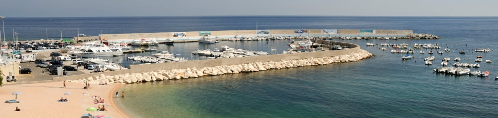 Boats at a harbor Cala Gonone Harbor Cala Gonone Nuoro Sardinia Italy Canvas Art - Panoramic Images (27 x 9)