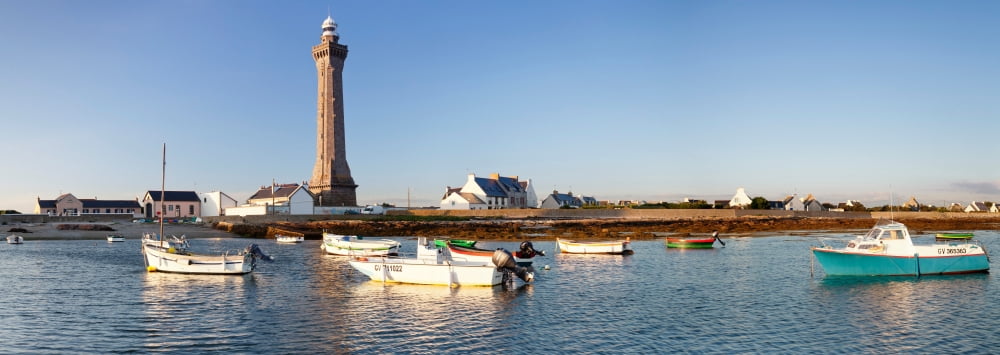 Boats in the sea with a lighthouse in the background Phare dEckmuhl Penmarch Finistere Brittany France Canvas Art - Panoramic Images (27 x 9)