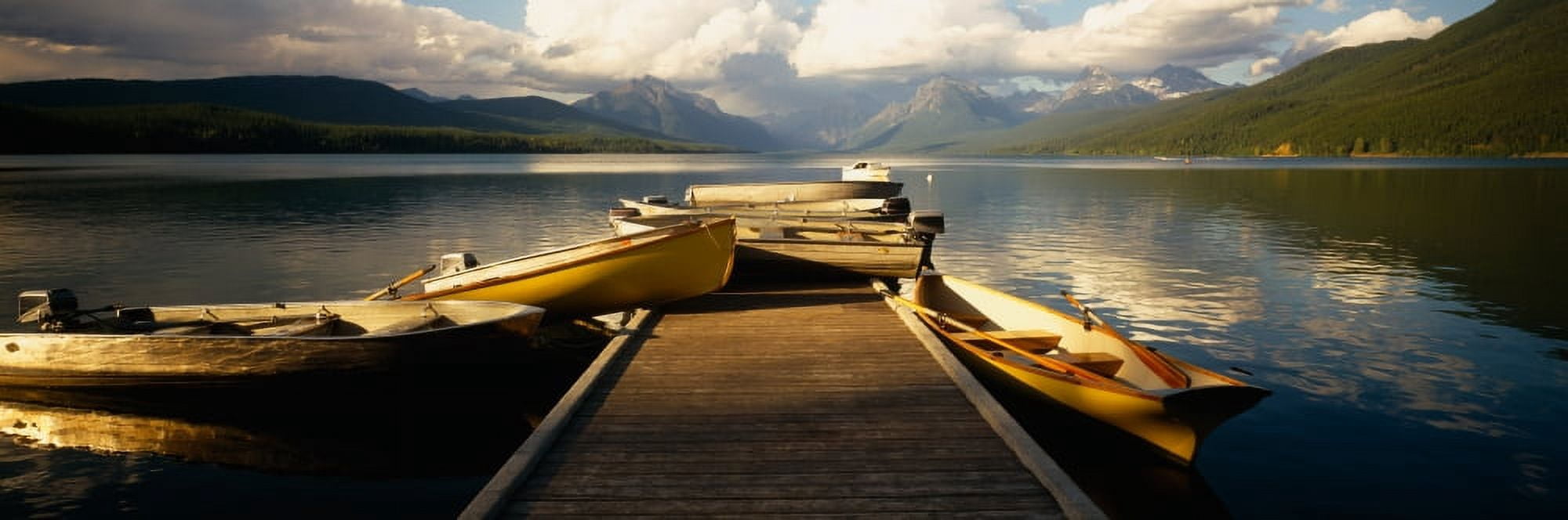 Boats moored at a dock McDonald Lake US Glacier National Park Montana USA Canvas Art - Panoramic Images (27 x 9)