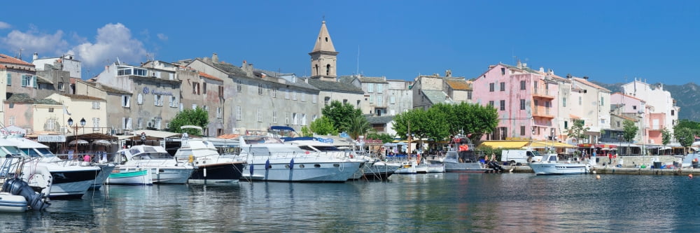 Boats at a port with a church in the background Port of Saint Florent Church Of Santa Maria Assunta Corsica France Canvas Art - Panoramic Images (36 x 12)