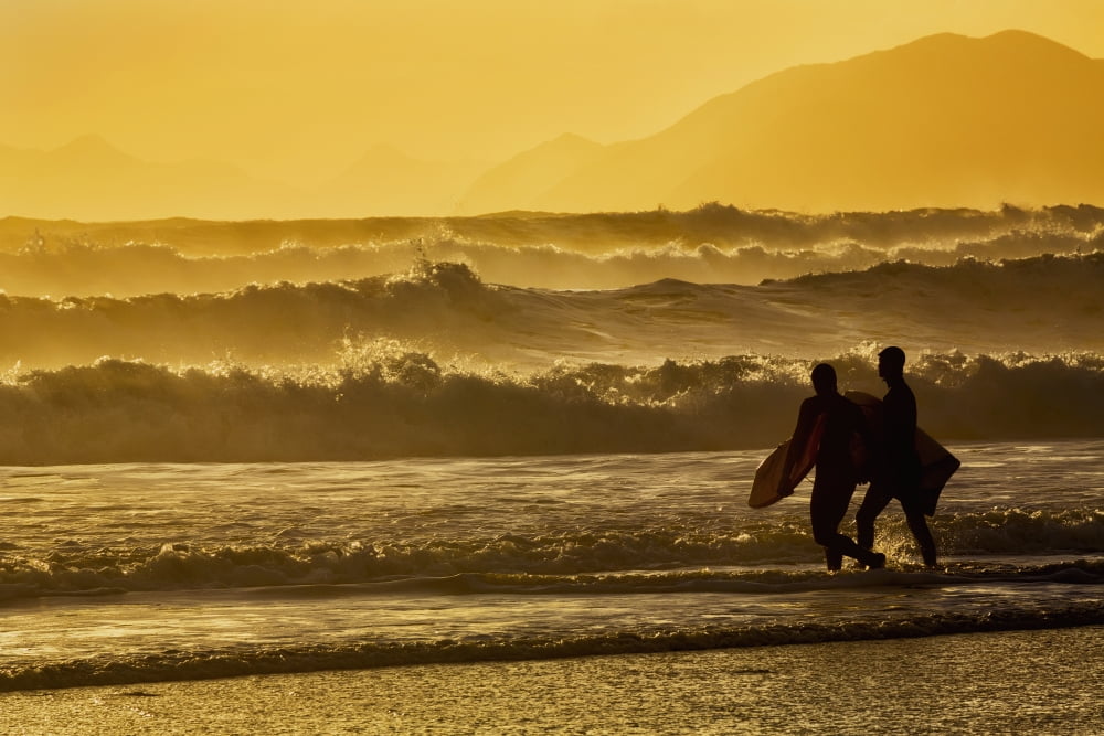 Body surfers walk in the water on the coast of Kodiak Island during late afternoon Pasagshak State Park Kodiak Island Alaska Canvas Art - Marion Owen Design Pics (38 x 24)