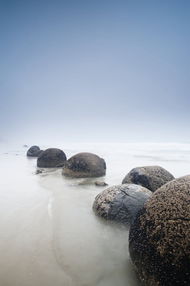 Boulders In A Row In The Shallow Water At The Beach Along The Coast Moeraki South Island New Zealand Canvas Art - David DuChemin Design Pics (12 x 19)