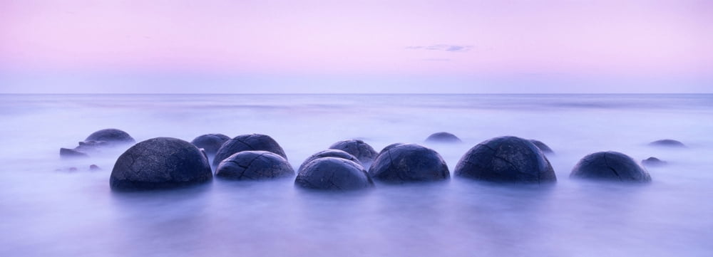 Boulders on the beach at sunrise South Island New Zealand Canvas Art - Panoramic Images (27 x 9)