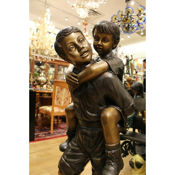 Boy Giving Girl Piggyback Ride Bronze Statue - Size: 23"L x 16"W x 46"H.