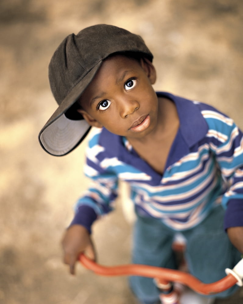 Boy Wearing Over Sized Hat Riding Bike Canvas Art - Ron Nickel Design Pics (26 x 32)