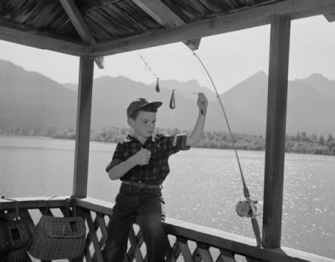 Boy adjusting fishing rod Canvas Art - (24 x 36)