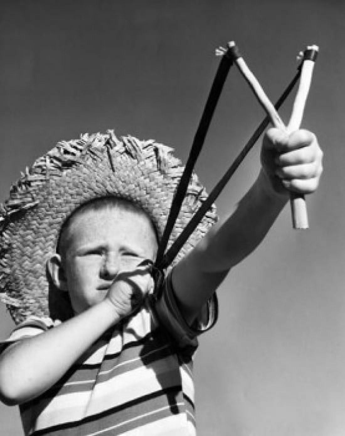 Boy aiming slingshot Canvas Art - (24 x 36)