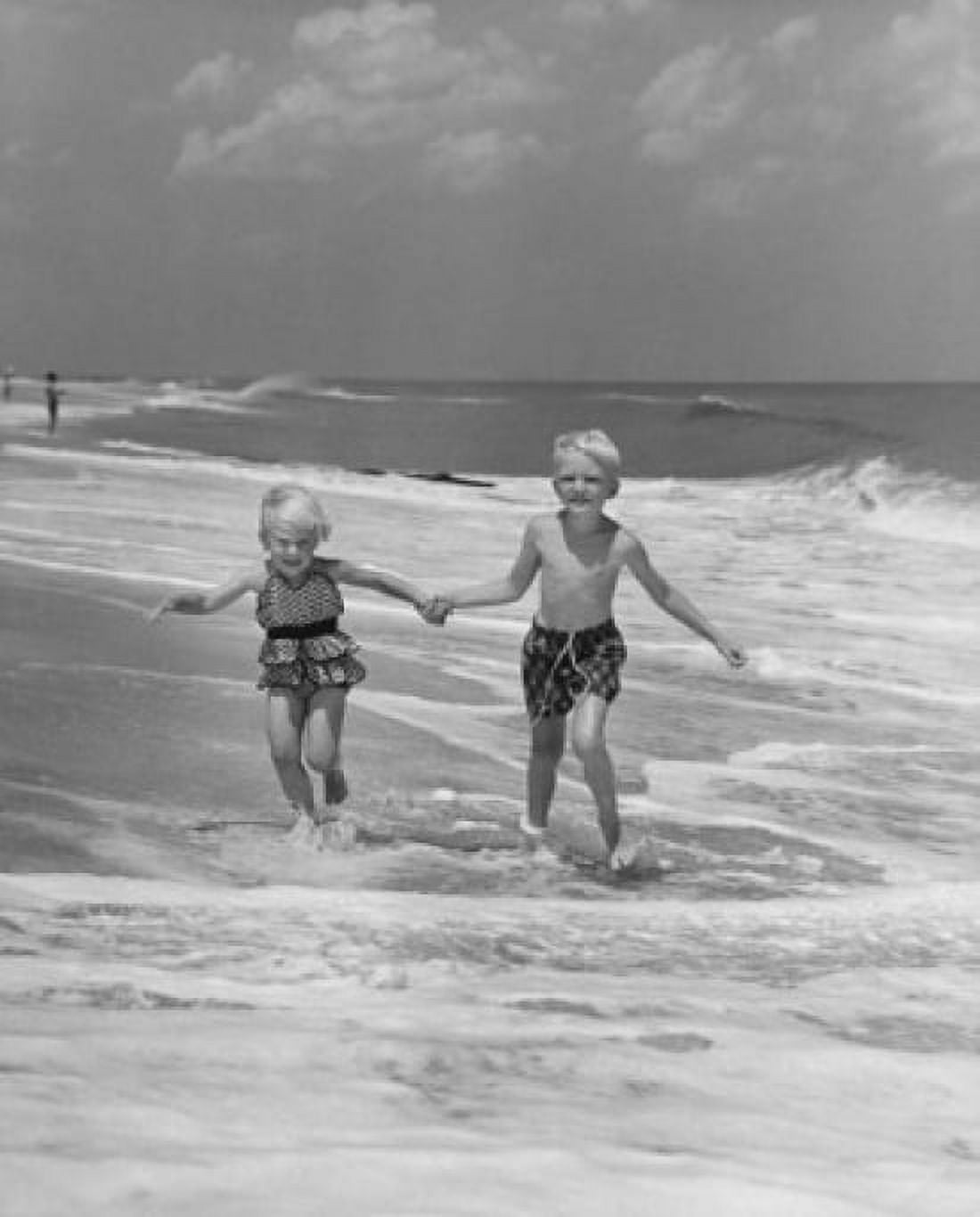 Boy and girl holding hands and running on the beach Canvas Art - (18 x 24)