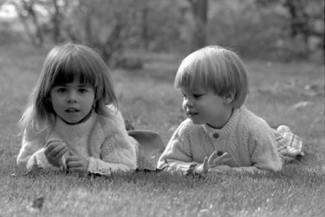 Boy and girl lying on grass Canvas Art - (18 x 24)