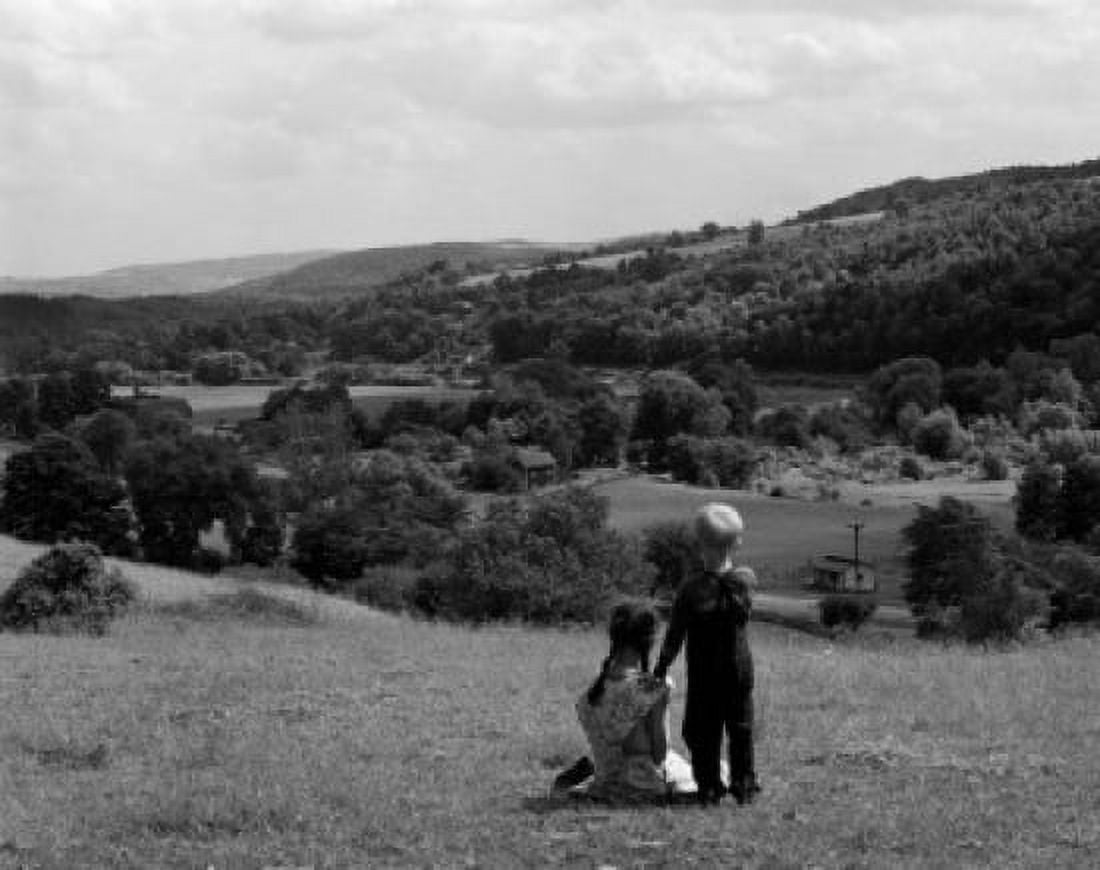 Boy and girl on hill looking down at view Canvas Art - (24 x 36)