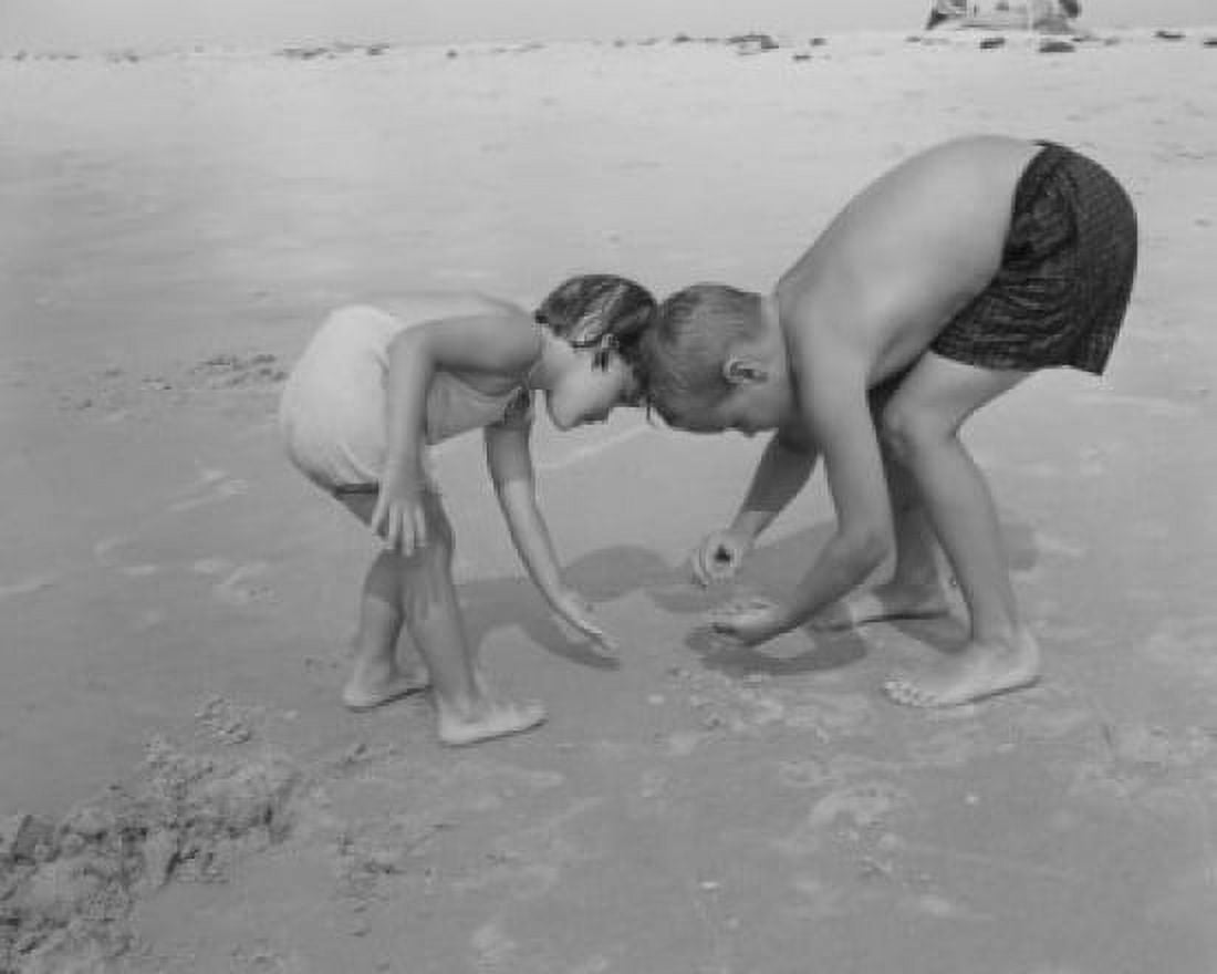 Boy and girl playing on beach Canvas Art - (24 x 36)