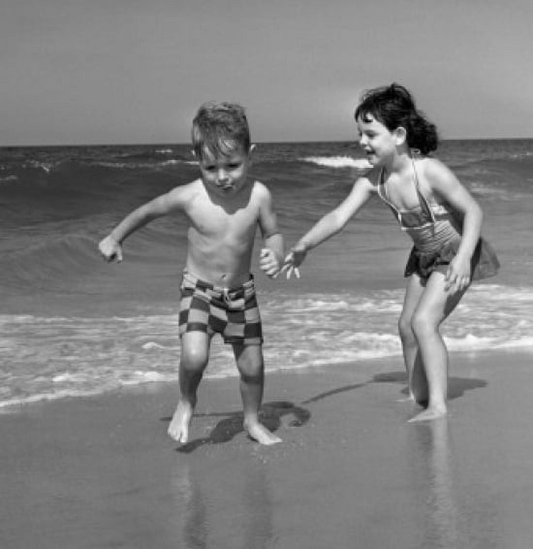 Boy and girl playing on sandy beach Canvas Art - (18 x 24)