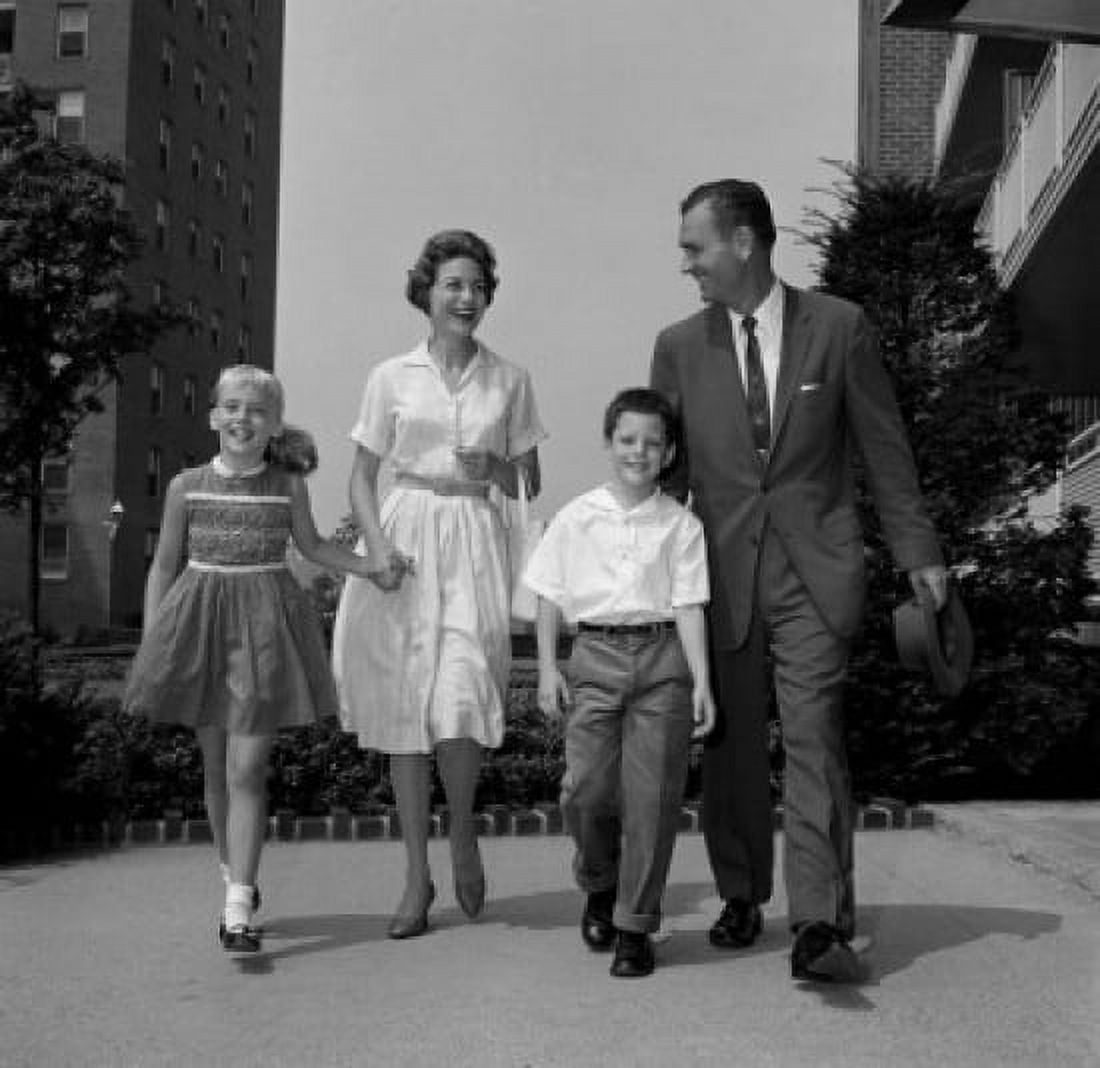 Boy and girl walking with parents outside flats Canvas Art - (24 x 36)