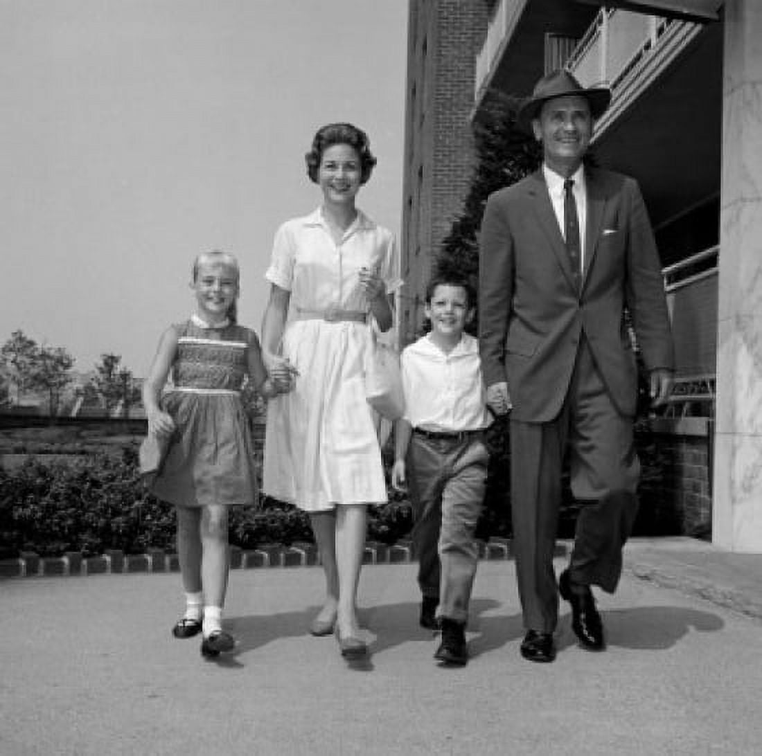 Boy and girl walking with parents outside flats Canvas Art - (24 x 36)