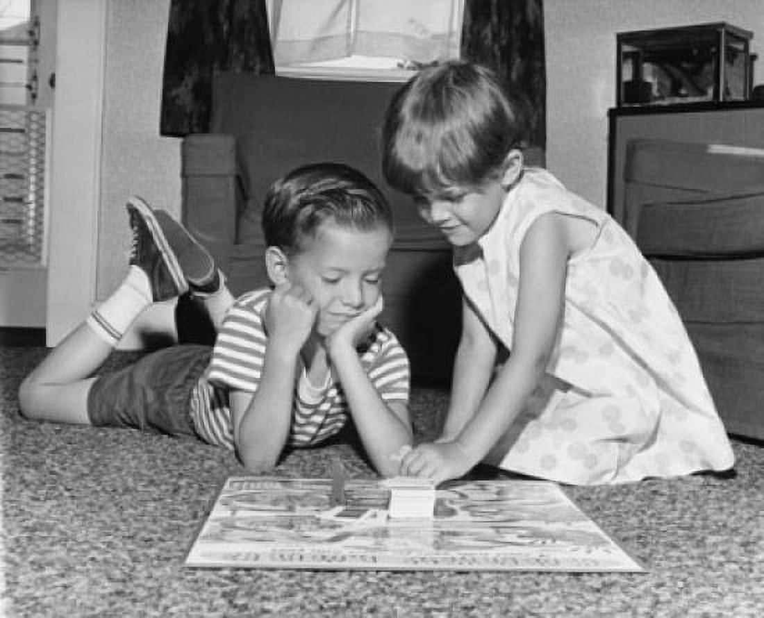 Boy and his sister playing a board game Canvas Art - (18 x 24)