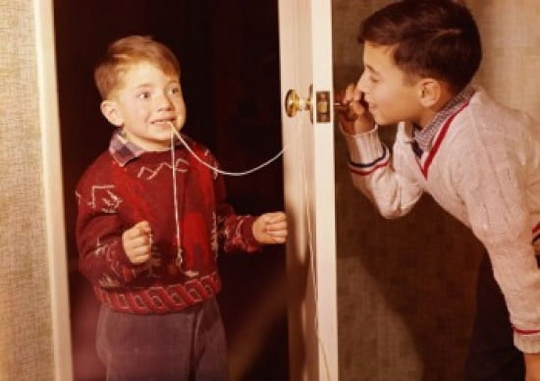 Boy attempting to extract his brothers loose tooth using string and doorknob technique Canvas Art - (18 x 24)